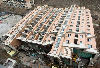 Newly built apartment building tips over in China